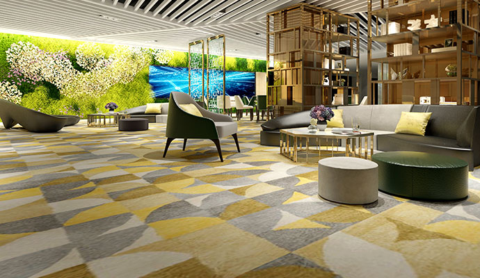 A large, fresh-smelling hotel lounge area with clean patterned carpets and modern seating.